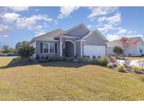 Charming single-story home featuring manicured landscaping, an attached garage, and a welcoming entrance at 748 Choctaw Dr., Conway, SC 29526