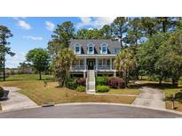 Charming raised beach home with a spacious front porch and mature landscaping in a desirable community at 854 Falkirk St., Myrtle Beach, SC 29579