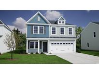 Charming two-story home with a light blue facade, attached garage, and well-manicured lawn at 1113 Hainer Place Dr, Conway, SC 29526