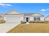 Charming single-story home with a two-car garage, brick accents, and a well-manicured lawn at 154 Six Mile Creek Dr., Georgetown, SC 29440