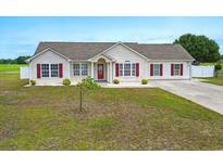 Charming single-story home with red shutters and a well-maintained lawn at 212 Sweetbay Magnolia St., Loris, SC 29569