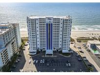 Exterior shot of the condominium building near the beach with an expansive parking lot at 2511 S Ocean Blvd. S # 1802B, Myrtle Beach, SC 29577
