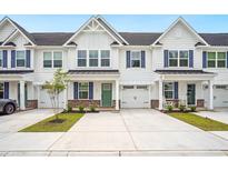 Charming townhouse with white siding, blue shutters, and well-manicured landscaping at 253 Bent Green Ct. # 70D, Murrells Inlet, SC 29576