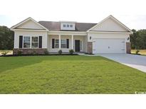Charming one-story home with manicured lawn, brick accents and attached two-car garage at 268 Stillbrook Dr., Longs, SC 29568