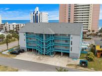 Coastal condo building with bright blue staircases and parking underneath, close to the beach at 2700 S Ocean Blvd. # A-3, North Myrtle Beach, SC 29582