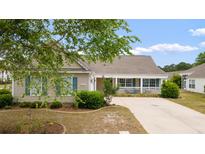 Charming one-story home with a welcoming front porch and manicured landscaping at 3136 Robins Nest Way, Myrtle Beach, SC 29579
