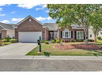 Charming brick home with well-maintained landscaping, a green lawn, and an attached two-car garage at 3802 Seedling Ct., North Myrtle Beach, SC 29582