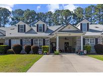 Charming home exterior boasting a well-manicured lawn and covered front porch, offering curb appeal and inviting entry at 439 Colonial Trace Dr. # 119, Longs, SC 29568