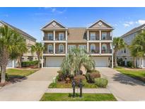 Charming two-story townhome featuring double balconies, lush landscaping and garage at 4413 Plantation Harbour Dr. # A, Little River, SC 29566