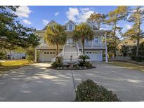 Charming two-story home with well-manicured landscaping, palm trees and circular driveway at 4616 Eyerly St., North Myrtle Beach, SC 29582