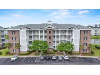 Stunning condominium building with ample parking and beautiful landscaping at 4887 Luster Leaf Circle # 105, Myrtle Beach, SC 29577