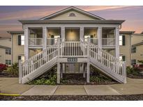 Inviting two-story condo featuring double staircases and a charming covered porch at 4925 Pond Shoals Ct. # 202, Myrtle Beach, SC 29579
