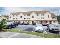 Exterior of the condo building with ample parking spaces available for residents and visitors at 510 Fairwood Lakes Dr. # 17-P, Myrtle Beach, SC 29588