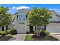 Charming townhome with a well-manicured lawn and an attached single-car garage offers inviting curb appeal at 101 Culpepper Way # 1007, Myrtle Beach, SC 29579