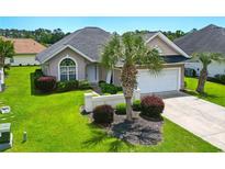 Well-maintained single-story home with a two-car garage and lush landscaping, including a mature palm tree at 10106 Duval Dr., Murrells Inlet, SC 29576