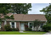 Charming single-story home features a brick accent, a well-manicured lawn, and mature trees providing shade at 105 Robin Ct., Murrells Inlet, SC 29576