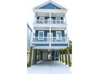 Stunning three-story beach home with balconies and a stylish blue exterior at 113B 11Th Ave. S, Surfside Beach, SC 29575