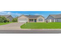 Charming single-story home with a well-manicured lawn and attached two car garage at 125 Balsa Dr., Longs, SC 29568