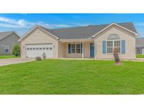 Charming single-story home featuring a well-manicured lawn and a two-car garage at 125 Balsa Dr., Longs, SC 29568