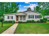 Charming one-story home with a well-manicured lawn, walkway and beautiful landscape at 1261 Parkhill Dr., Conway, SC 29526