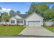 Charming single-story home with a well-manicured lawn, a two-car garage, and appealing curb appeal at 1307 Collins Park St., Conway, SC 29526
