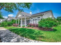 Charming single-story home with well-manicured lawn and inviting front porch with supporting columns at 1508 Waverly Ave., Myrtle Beach, SC 29577