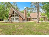 Charming two-story home with brick facade, fenced yard, and expansive windows for a bright interior at 206 Dogwood Dr., Myrtle Beach, SC 29575