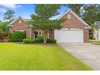Charming single-story brick home with a well-manicured lawn and attached two-car garage at 3 Birdsong Ct., Murrells Inlet, SC 29576