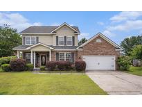 Two-story home with brick and vinyl siding, well-maintained lawn and two-car garage at 3605 Kingsley Dr., Myrtle Beach, SC 29588