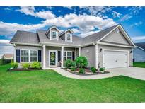 Charming single-story home with well-manicured lawn, landscaped garden, and inviting covered entryway at 364 Copperwood Loop, Conway, SC 29526