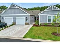 Charming home featuring a two-car garage, manicured lawn, and inviting facade at 4027 Taranto Loop # C, Myrtle Beach, SC 29579