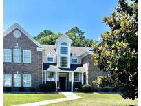 Inviting exterior of a two-story townhome with a well-manicured lawn and a beautifully designed facade at 4394 Daphne Ln. # F, Murrells Inlet, SC 29576