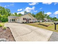 Charming single-story home with yellow siding, red shutters, landscaped yard, and long driveway at 454 Sean River Rd., Conway, SC 29526