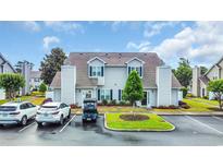 Charming townhouse featuring a manicured lawn, two-story structure, and convenient parking at 503 20Th Ave. N # 46 B, North Myrtle Beach, SC 29582