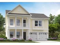 Charming two-story home boasts a welcoming double porch, complemented by a two-car garage and manicured landscaping at 524 Magnolia Terrace Dr, Myrtle Beach, SC 29579