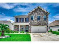 Charming two-story home with brick and siding, complemented by a well-manicured lawn and garden at 5406 Longhorn Dr., Myrtle Beach, SC 29588