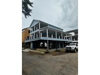 Coastal home with a blue exterior, black railing, and a large covered deck on multiple levels at 6001 - Mh-13B S Kings Hwy., Myrtle Beach, SC 29575