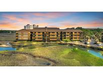 Beautiful exterior view of condo complex and intercoastal waterway at sunset at 9501 Shore Dr. # A-211, Myrtle Beach, SC 29572