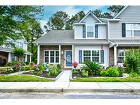 Charming two-story townhome with well-manicured landscaping and inviting front porch at 990 Palisade Circle, Myrtle Beach, SC 29577