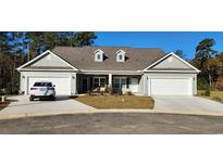 Charming home exterior featuring a two-car garage, pristine landscaping, and a welcoming entrance at Tbd Aft Ct # 101, Murrells Inlet, SC 29576
