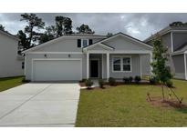 Charming single-Gathering home featuring a two-car garage and well-maintained front lawn at 1019 Laconic Dr., Myrtle Beach, SC 29588