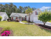 Charming single-Gathering home with lush green lawn, manicured landscaping and a driveway at 1105 Lampwick Ln., Murrells Inlet, SC 29576