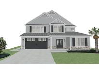 Two-story home with a two-car garage, neutral siding and stone accents on the front exterior elevation at 124 Palmetto Harbour Dr., North Myrtle Beach, SC 29582
