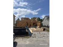 Framing of a new two-story house under construction, displaying its structural design and progress at 140 Palmetto Harbour Dr., North Myrtle Beach, SC 29582