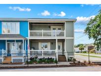 Charming two-story townhome with double balconies and a well-maintained, fenced yard at 2102 S Ocean Blvd. # D, North Myrtle Beach, SC 29582