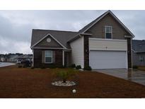 Charming single-Gathering home featuring a two-car garage, landscaped front yard, and a mix of brick and vinyl siding at 224 Fishburn Dr., Conway, SC 29526