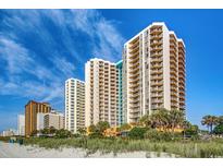 Beautiful beachfront condos against a bright blue sky offering luxurious coastal living at 2710 N Ocean Blvd. # 402, Myrtle Beach, SC 29577