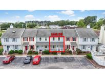 Charming townhome with colorful facade, manicured landscaping, and parking at 3008 Church St. # D3, Myrtle Beach, SC 29577