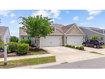 Charming home featuring a well-manicured lawn, two-car garage and neutral siding and trim at 4359 Livorn Loop # 4359, Myrtle Beach, SC 29579