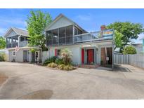 Inviting two-story beach house with a screened porch and covered parking at 507-C 2Nd Ave. N, North Myrtle Beach, SC 29582